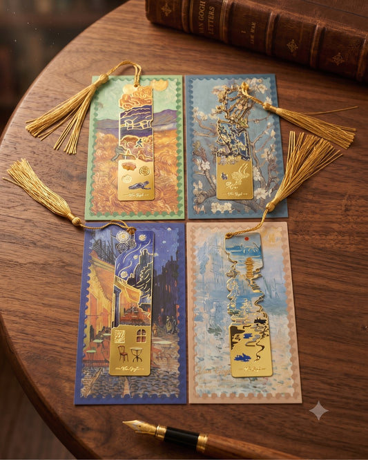 Four Van Gogh-inspired bookmarks with gold tassels are laid out on a wooden table next to a vintage book and a fountain pen.