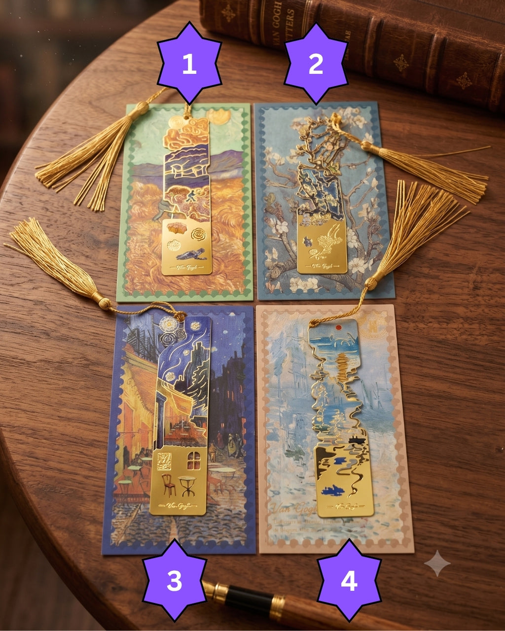 Four bookmarks with gold tassels are displayed on a wooden table next to a leather-bound book. Each bookmark features a cutout metal design inspired by famous paintings, set against a decorative background with a postcard-like border.