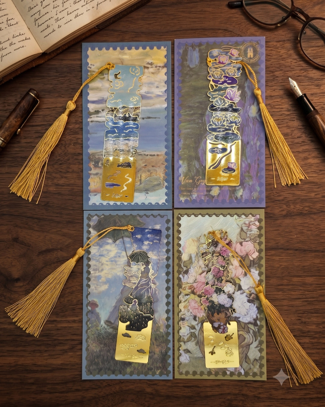 Four ornate bookmarks featuring different artistic scenes: a seascape, water lilies, a woman with an umbrella, and a floral arrangement. Each bookmark has a gold tassel.