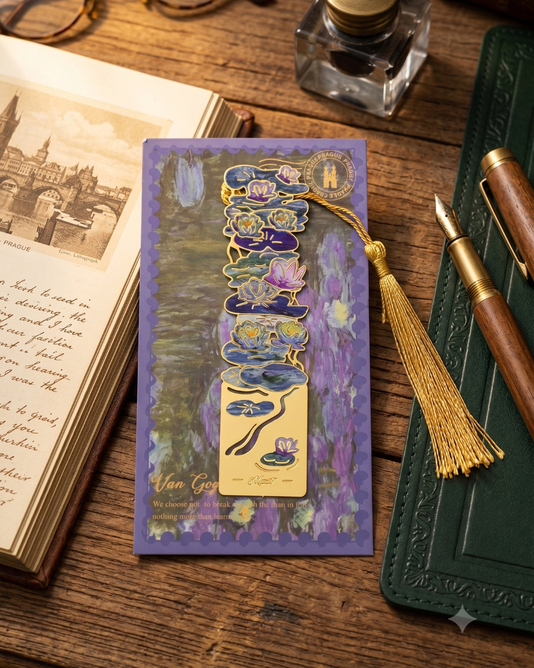 A bookmark featuring a golden metal cutout of water lilies and lily pads, set against a purple background depicting a water lily pond. The bookmark has a gold tassel and is placed on a wooden surface next to an open book and a fountain pen.